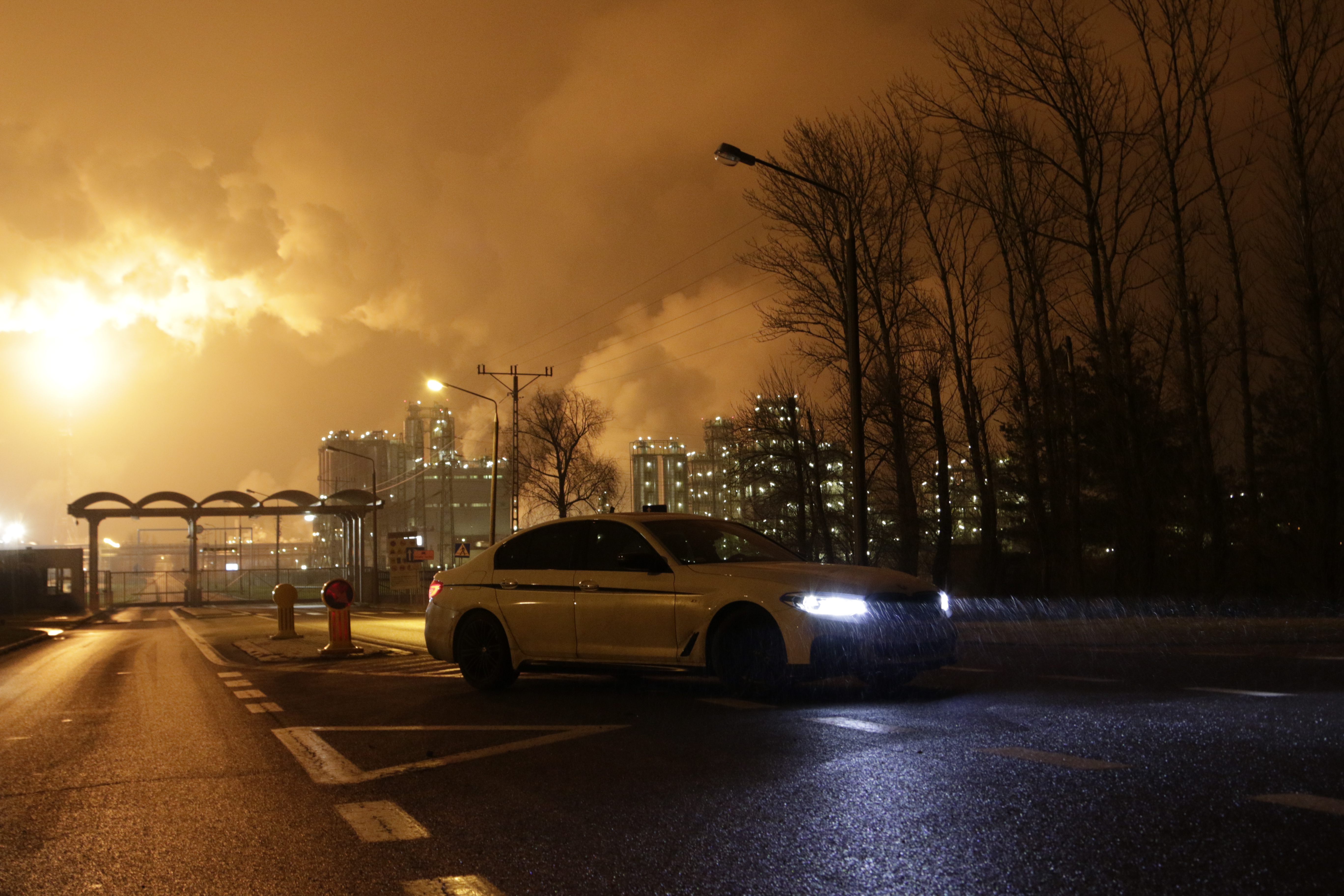 BMW 5 Series przy rafinerii nocą
